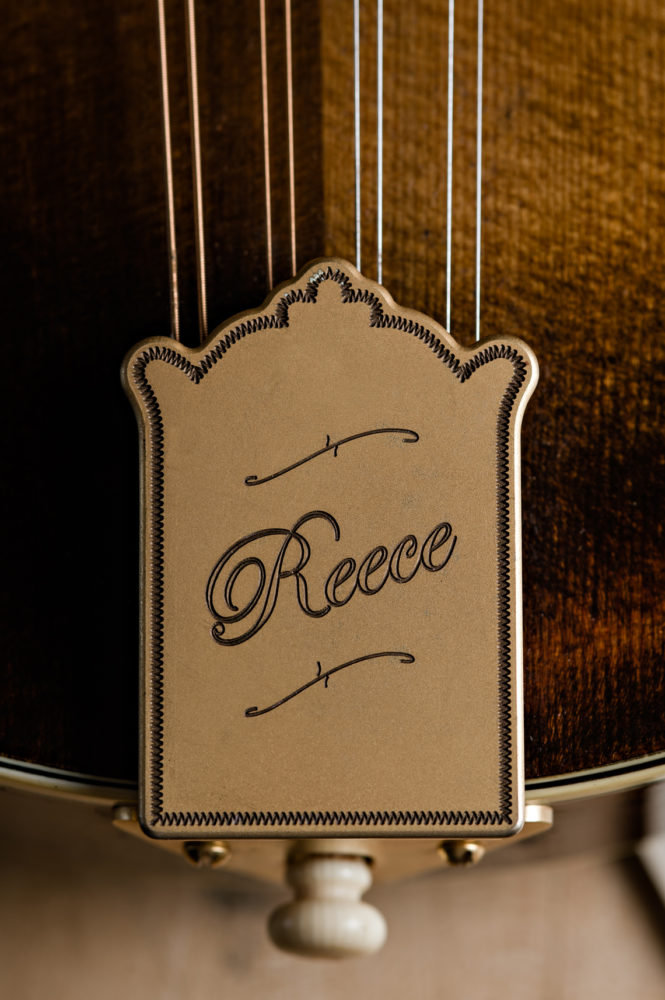 Reece spelled in cursive on string instrument