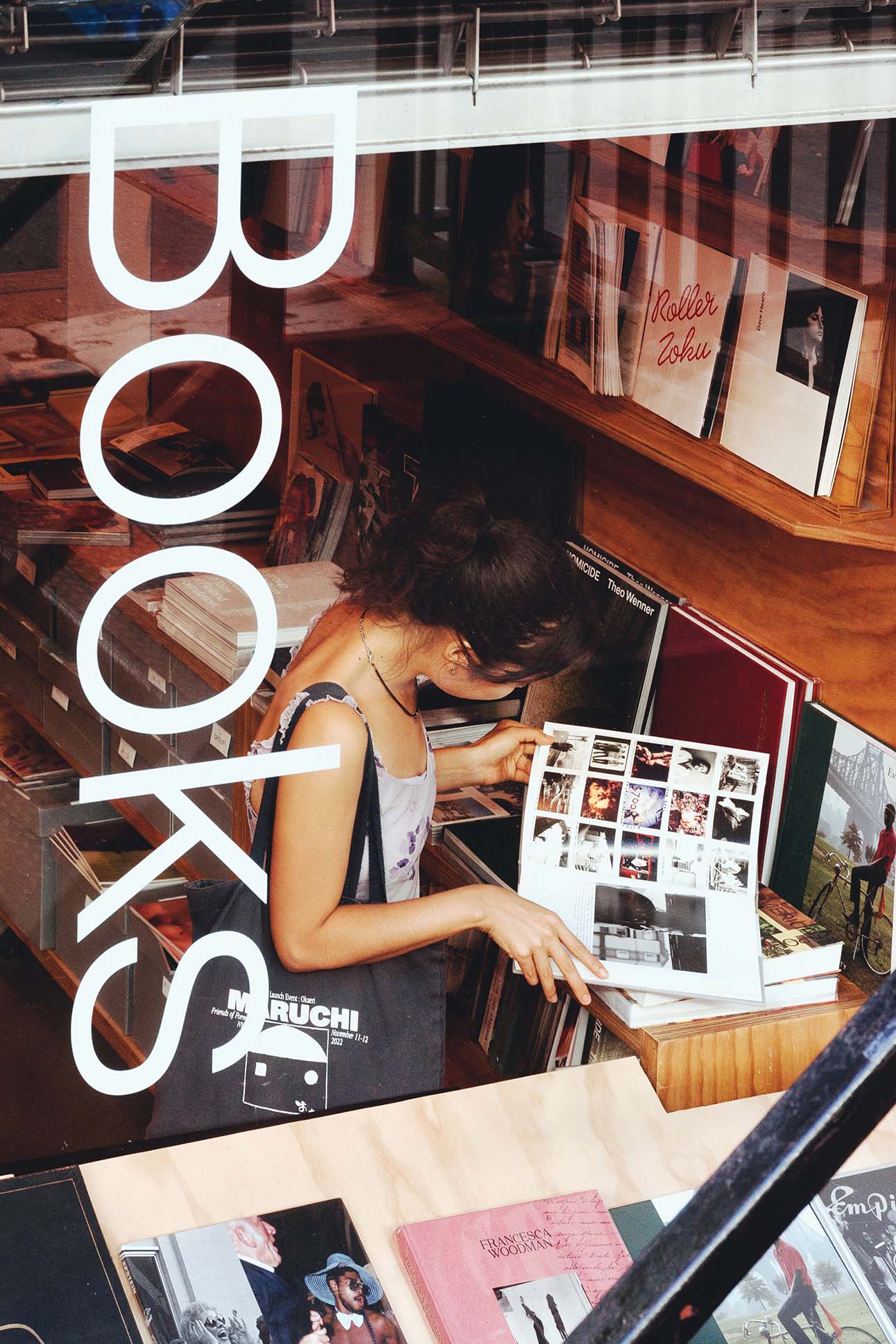 Emily May Jampel looking through books in Dashwood Books located in New York