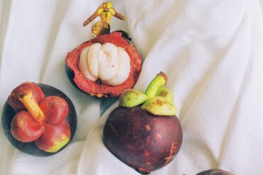a group of fruit on a white cloth