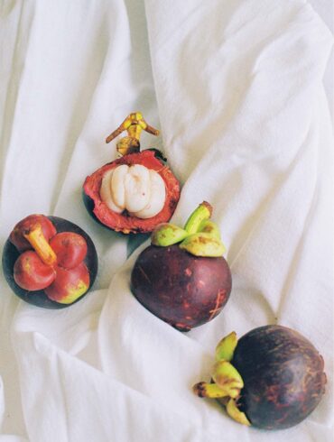 a group of fruit on a white cloth