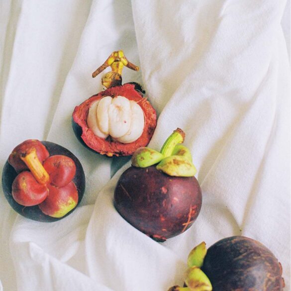 a group of fruit on a white cloth