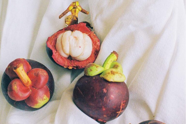 a group of fruit on a white cloth