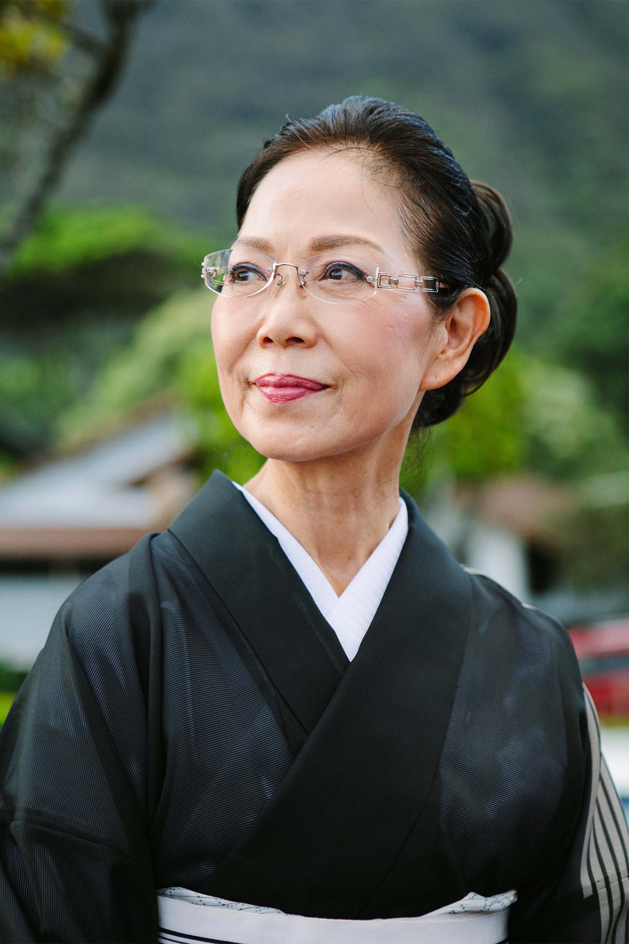 a person wearing glasses and a black robe