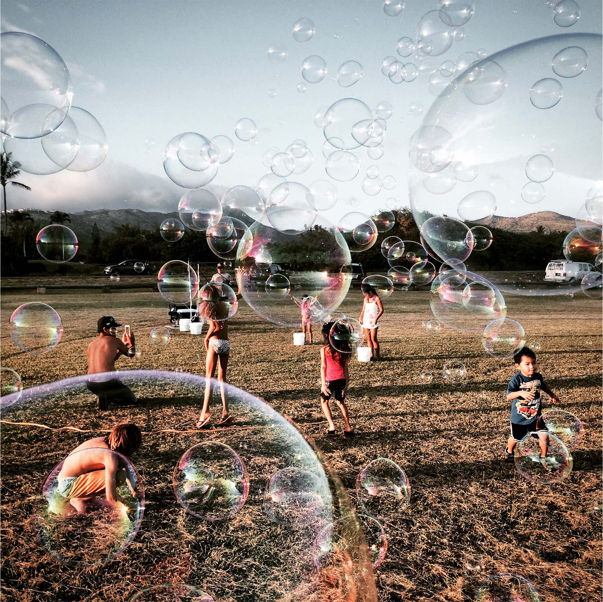 kids playing in the park with bubble