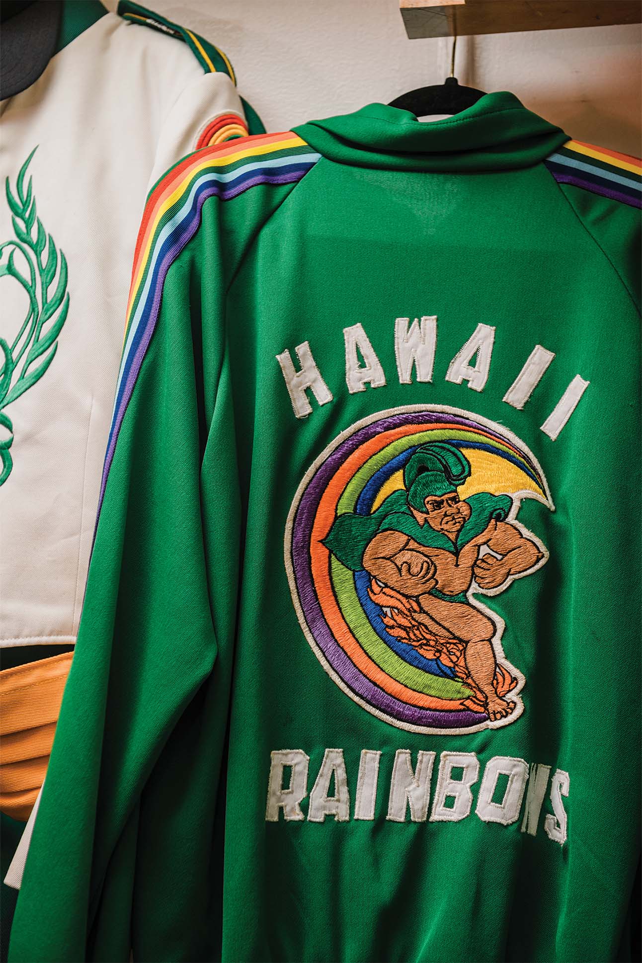 a green jacket with a rainbow design
