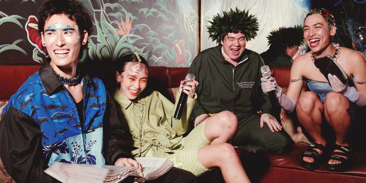 a group of people sitting on a couch with microphones