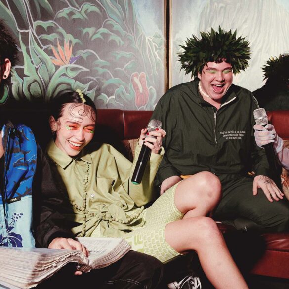 a group of people sitting on a couch with microphones